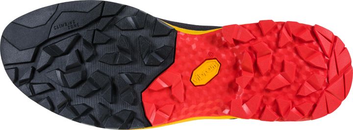 Sohle eines Zustiegsschuhs von unten: vorn schwarzes, fein strukturiertes Gummi, hinten rotes Stollenprofil